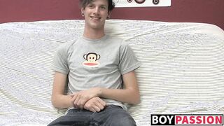 Cute gay guy Danny jerks off his cock on couch solo